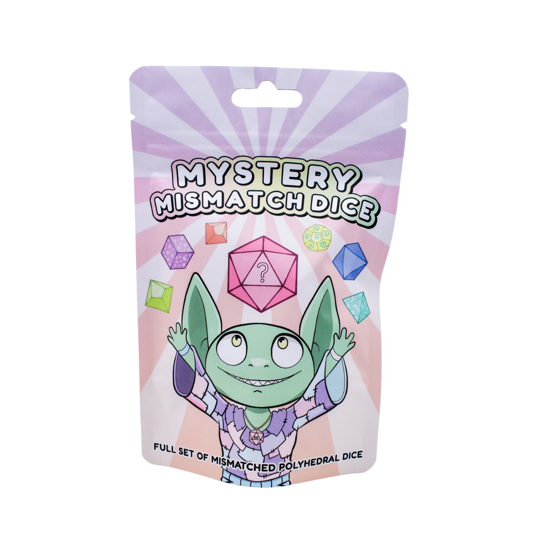 Packaging for Mystery Mismatch Dice with a cartoon goblin and colourful dice on a pink background.
